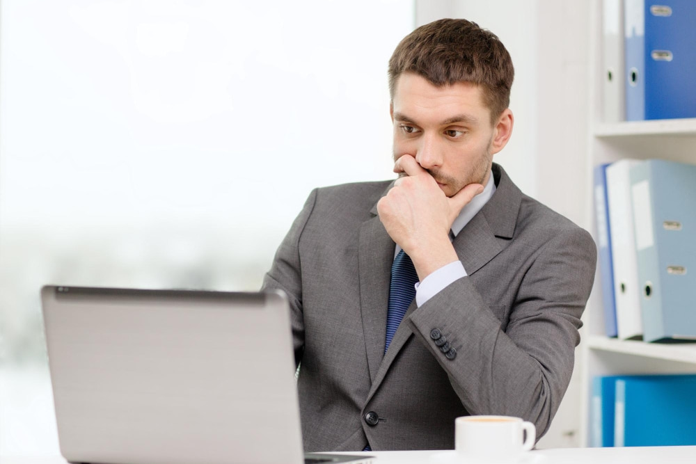 Manager ponders objectives to define business goal to choose web design agency for growth