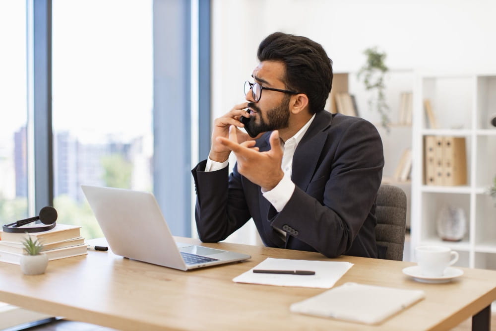 Businessman talking on the phone with a web design agency about post-launch website support